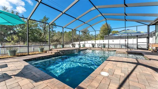 a view of a swimming pool with a patio