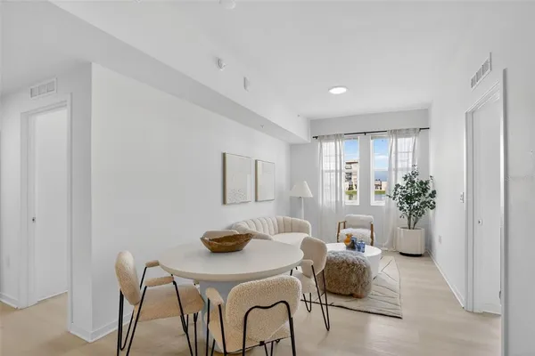 a living room with furniture and potted plant