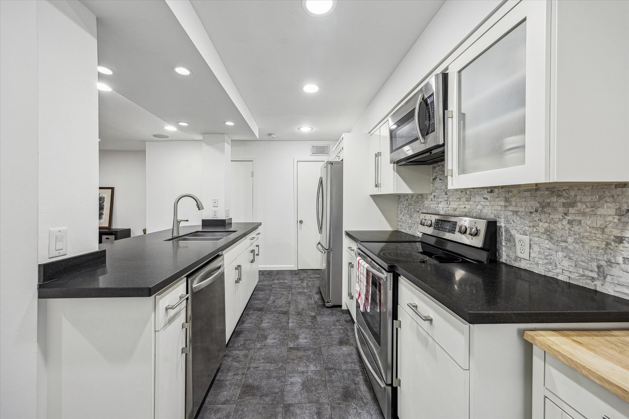 5524 Beverly Hill Street, Unit 2 Houston, TX 77056 - Photo 8 of 29 Another view of the kitchen looking towards the half bath and the pantry.