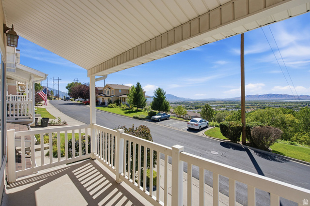 1305 Alpine Way Provo, UT 84606 - Photo 42 of 56 Covered front porch with white railings and a concrete floor