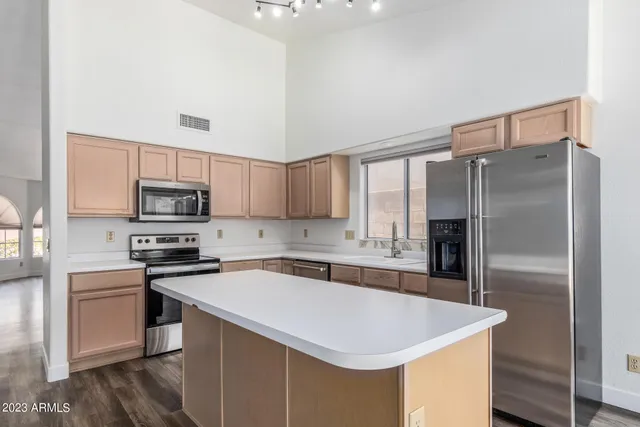 a kitchen with stainless steel appliances a white stove top oven sink and cabinets