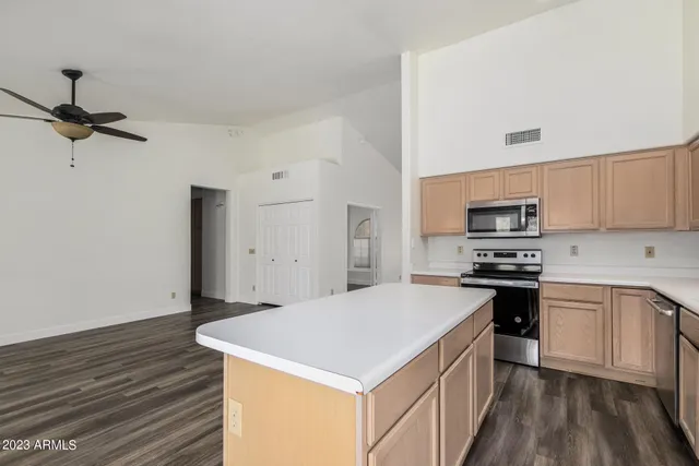 an open kitchen with a sink and a fireplace