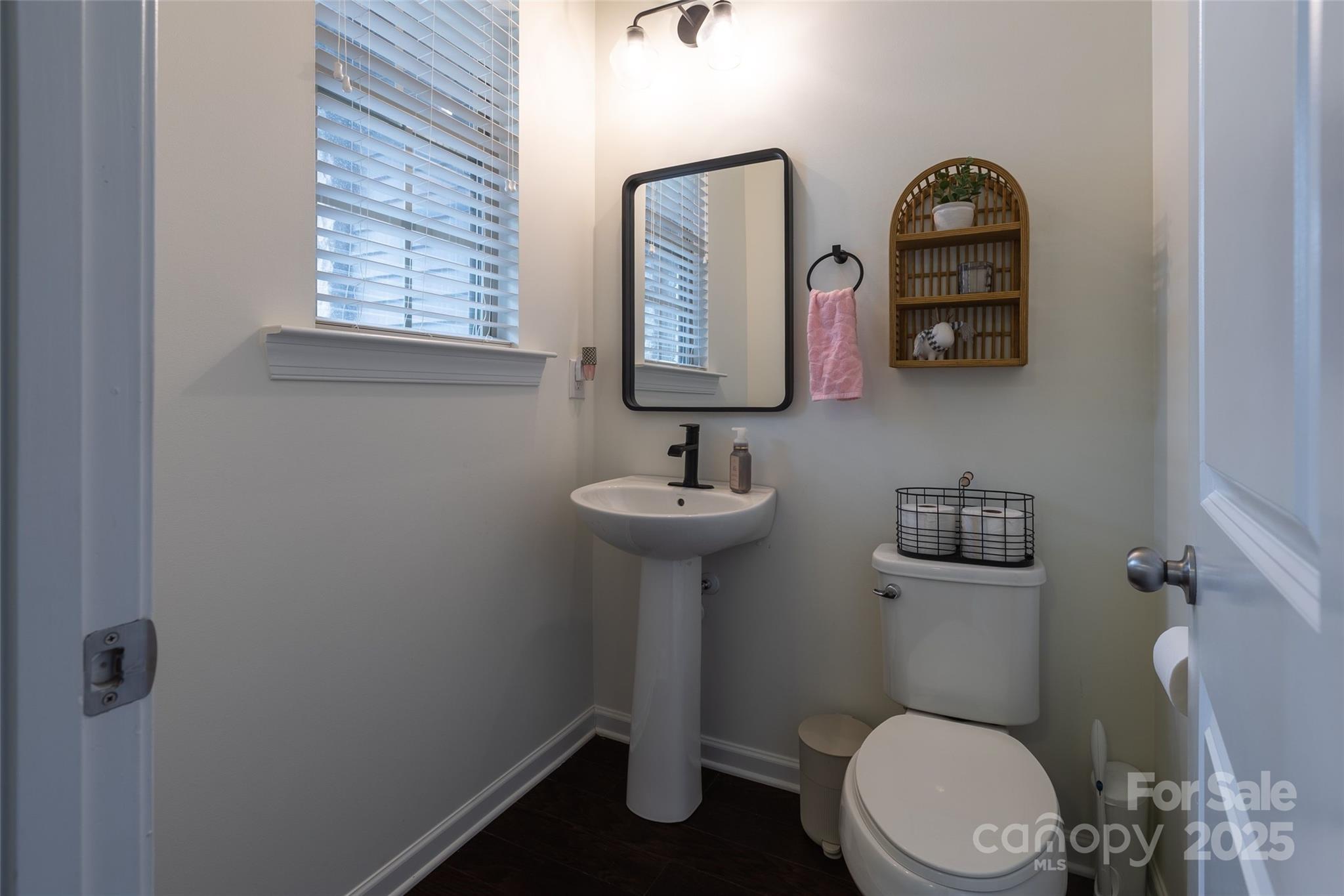 1019 Archibald Avenue Fort Mill, SC 29708 - Photo 12 of 26 a bathroom with a toilet a sink and mirror