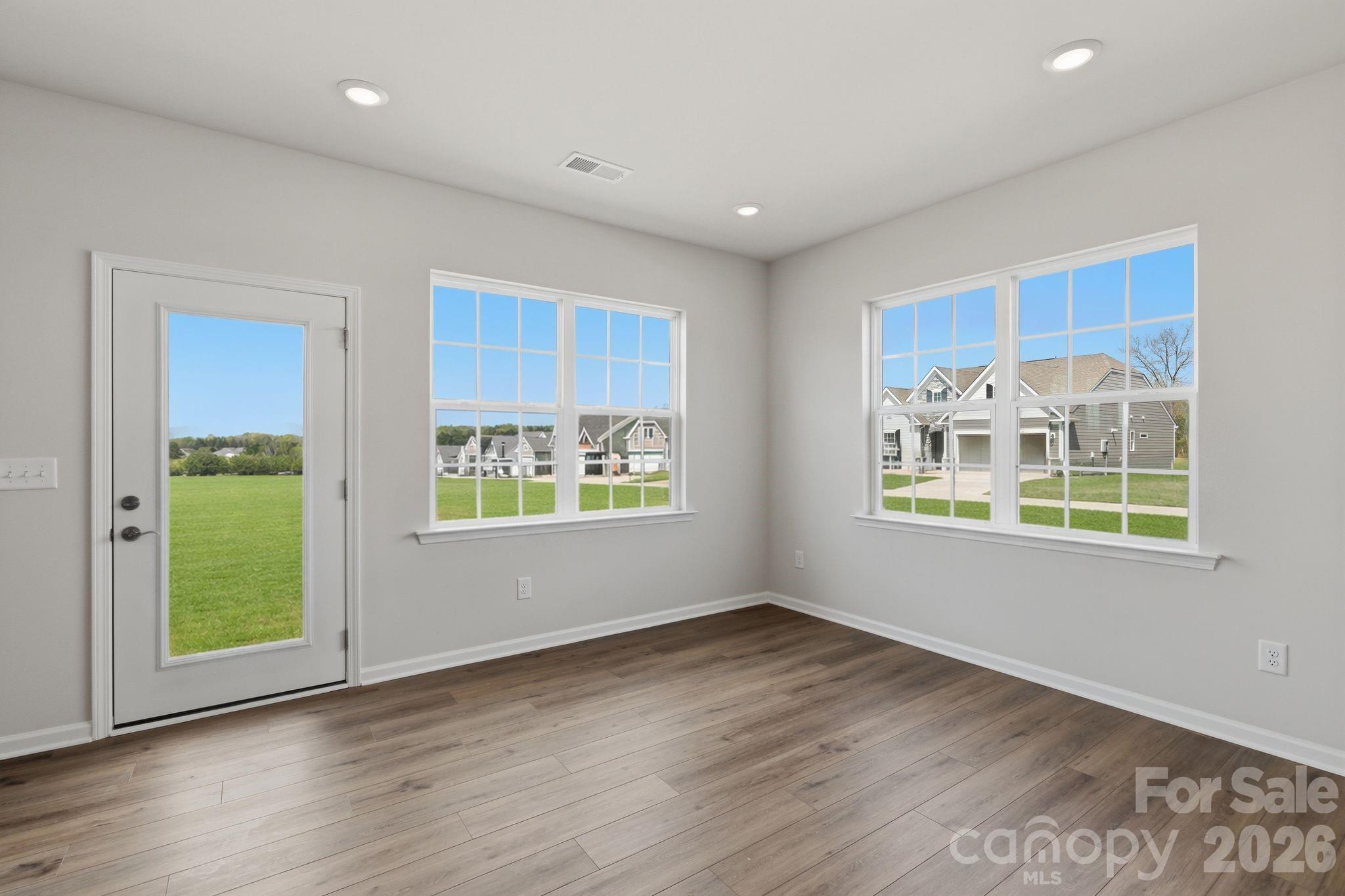 5475 Redbud Road, Unit 57 Lancaster, SC 29720 - Photo 7 of 30 a view of an empty room with a window and wooden floor