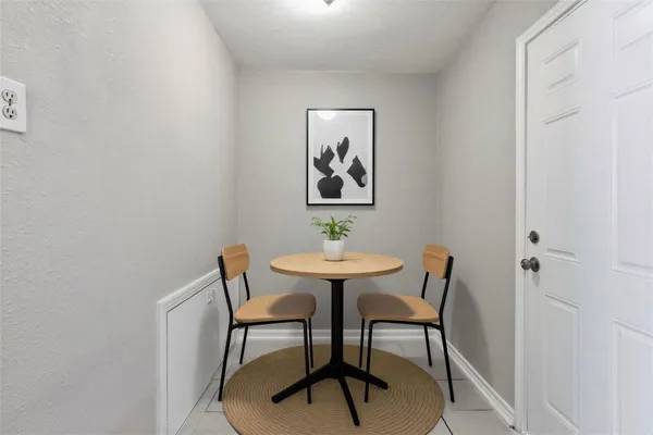 a view of a room with furniture and wooden floor