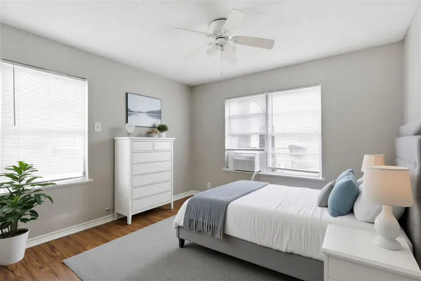 a bedroom with a bed and a potted plant