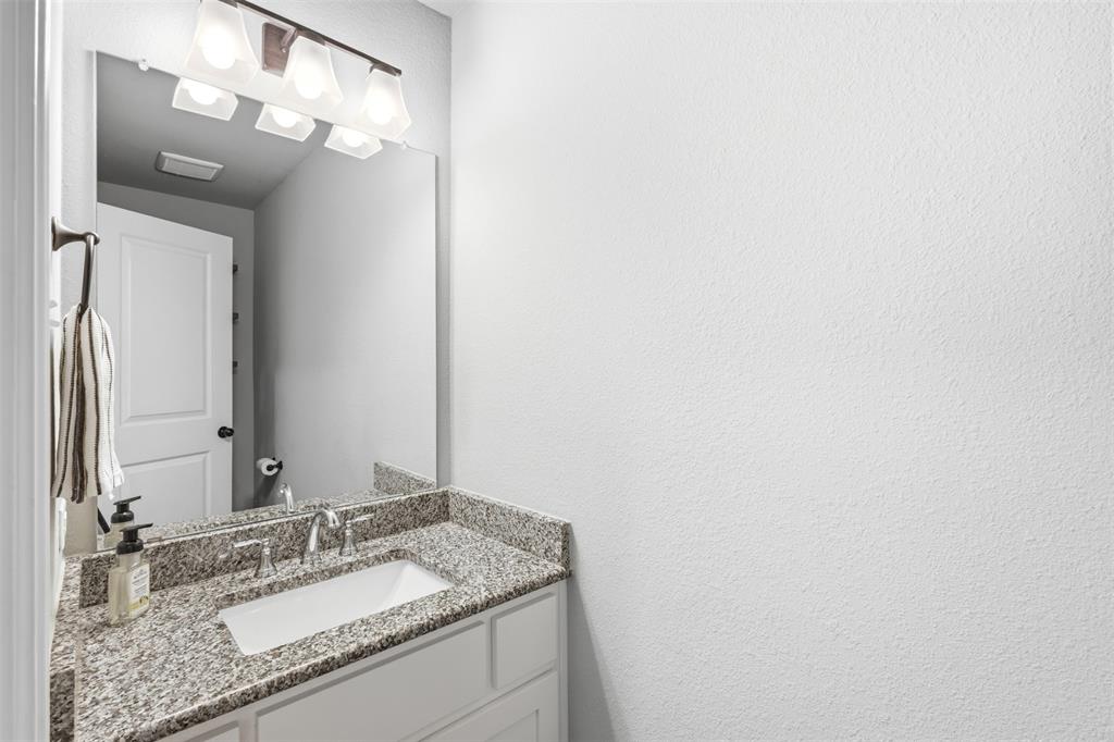 2990 Wilson Road Palmer, TX 75152 - Photo 20 of 40 a bathroom with a granite countertop sink and a mirror