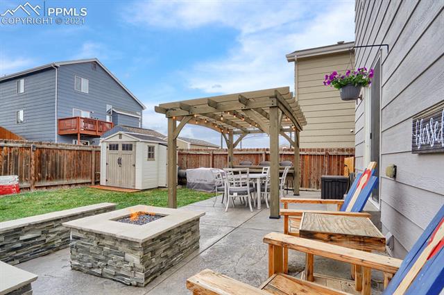 5215 Gentle Wind Road Colorado Springs, CO 80922 - Photo 2 of 43 Custom stamped concrete with gas firepit and pergola