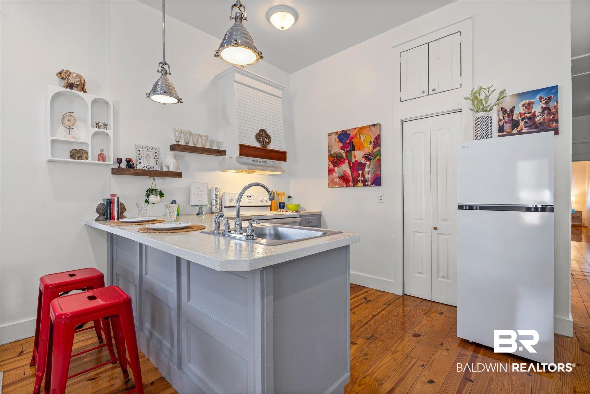 951 Montgomery Street Mobile, AL 36604 - Photo 6 of 22 Compact kitchen featuring wood-finish flooring, a light-toned countertop, and a stainless steel sink