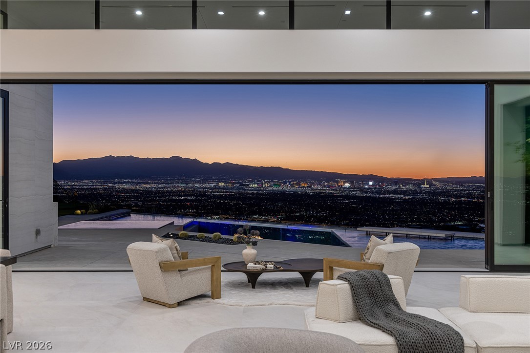 563 Grand Rim Drive Henderson, NV 89012 - Photo 44 of 70 Uninterrupted city light panoramas from this elevated, open-concept living space with sleek floor-to-ceiling glass.