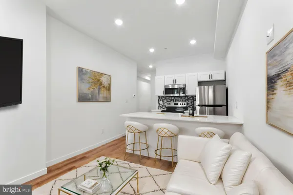 a kitchen with stainless steel appliances granite countertop a sink and a refrigerator