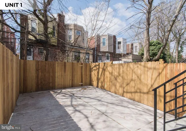 a backyard of a house with large trees