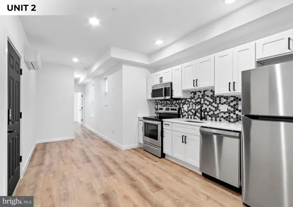 a kitchen with white cabinets and white appliances