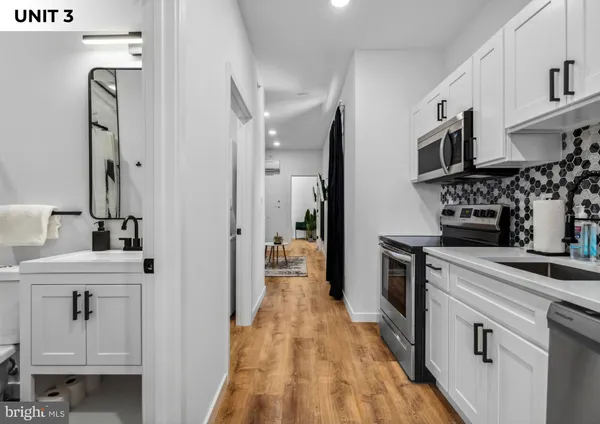a kitchen with stainless steel appliances a sink stove and refrigerator