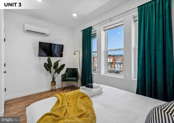a bedroom with a bed and a potted plant