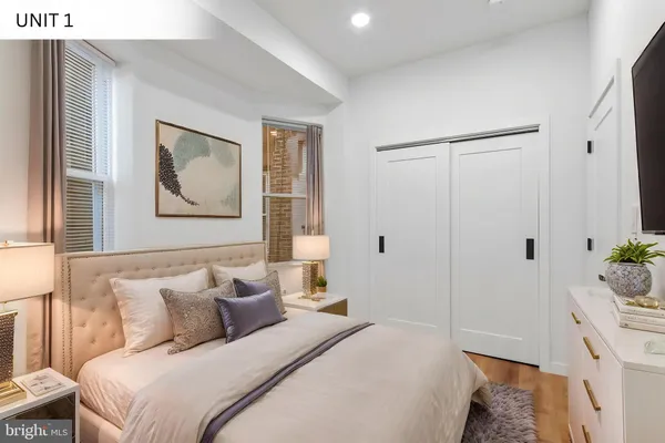 a bedroom with a bed and a painting on the wall