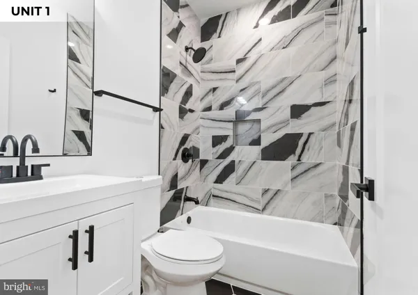 a bathroom with a sink a toilet and a shower