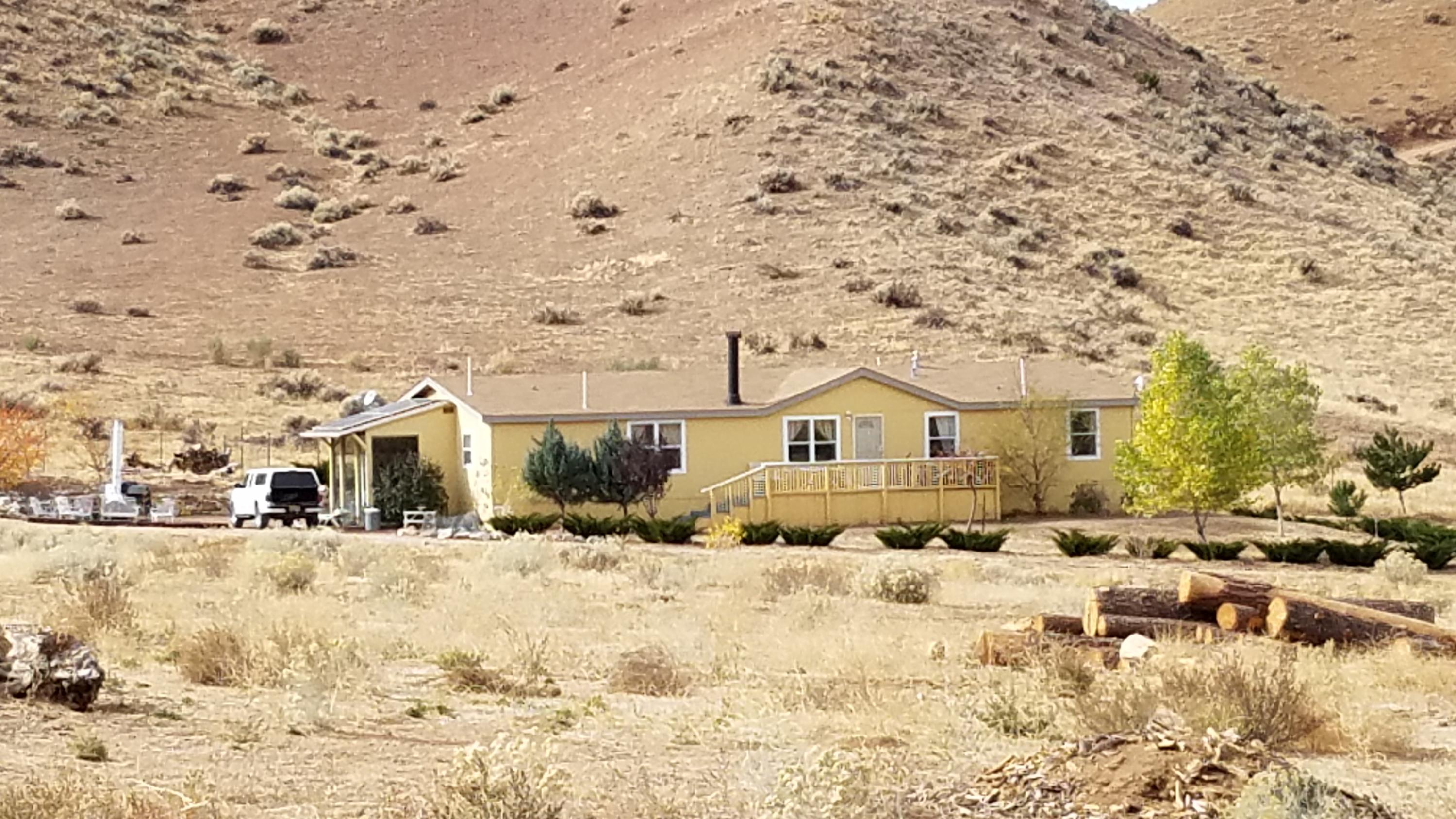 17215 Tehachapi Willow Springs Road Tehachapi, CA 93561 - Photo 1 of 45 a view of a white house with a snow in the background