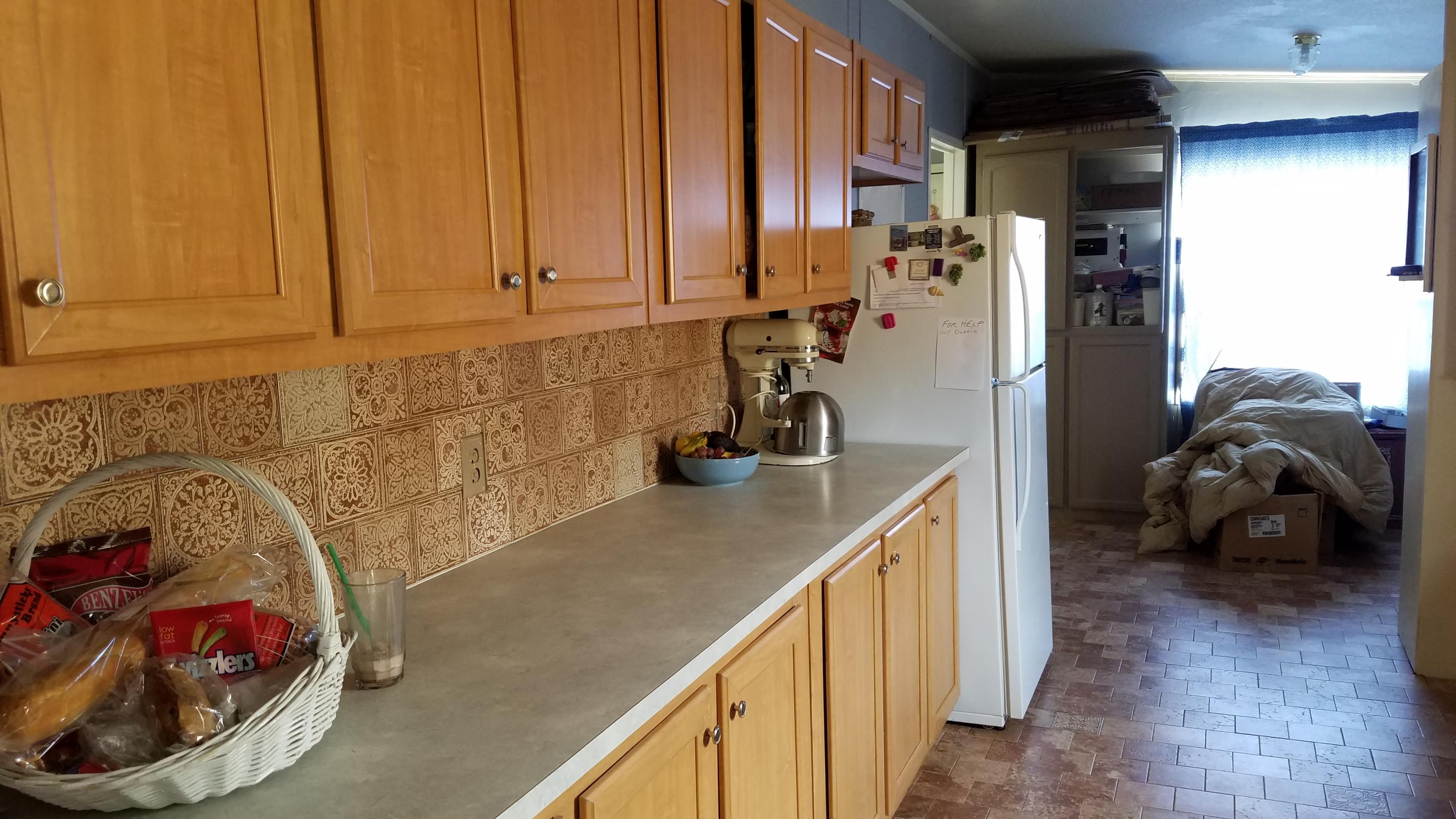 17215 Tehachapi Willow Springs Road Tehachapi, CA 93561 - Photo 19 of 45 a kitchen with stainless steel appliances granite countertop a sink a refrigerator and a stove