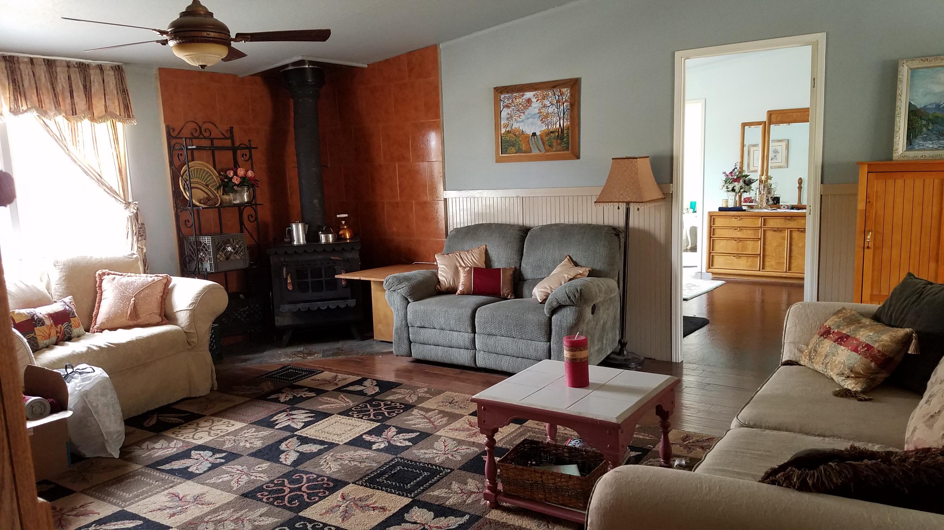 17215 Tehachapi Willow Springs Road Tehachapi, CA 93561 - Photo 2 of 45 a living room with furniture and a rug