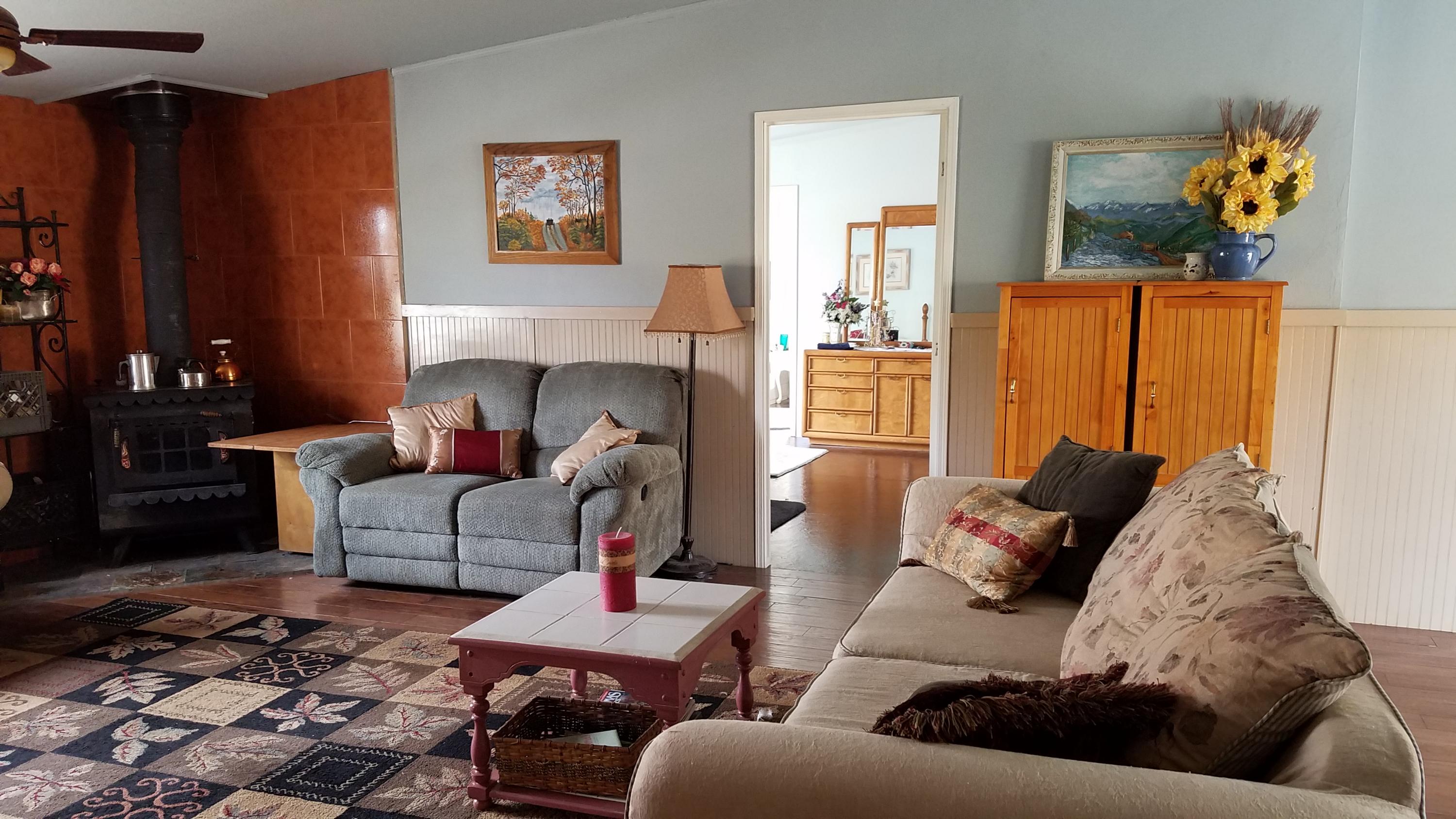 17215 Tehachapi Willow Springs Road Tehachapi, CA 93561 - Photo 3 of 45 a living room with furniture and a couch