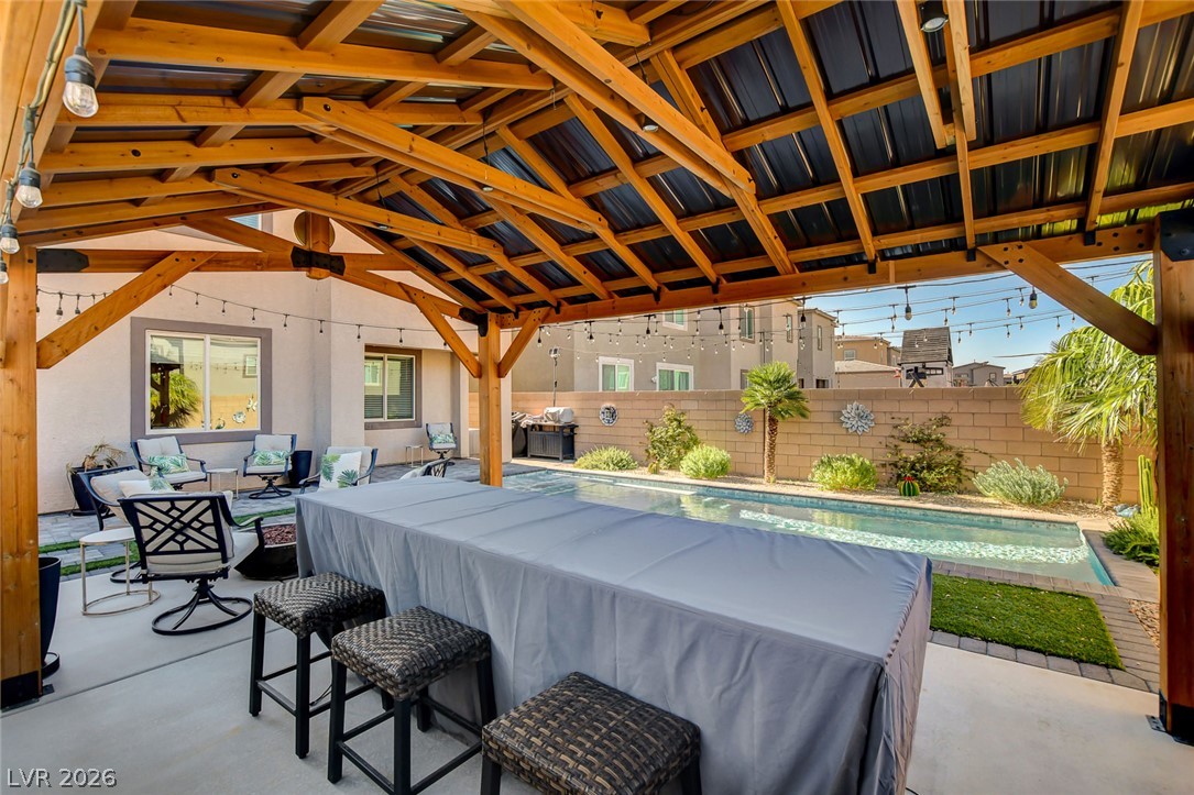 9688 Rankin Rdg Court Las Vegas, NV 89178 - Photo 48 of 53 An inviting backyard oasis offers a covered patio for relaxing by the pristine swimming pool.