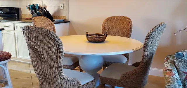 a dining room with furniture and natural light
