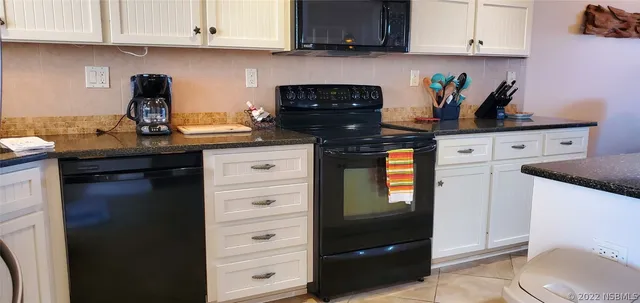 a kitchen with stainless steel appliances granite countertop a stove a refrigerator and cabinets