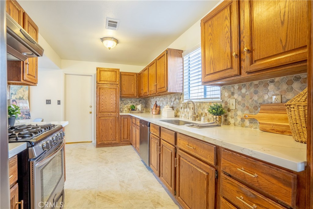 3610 Cartwright Street Pasadena, CA 91107 - Photo 38 of 75 a kitchen with stainless steel appliances granite countertop a stove a sink and a refrigerator