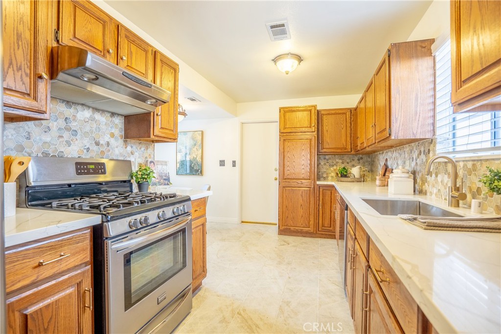 3610 Cartwright Street Pasadena, CA 91107 - Photo 40 of 75 a kitchen with stainless steel appliances granite countertop a stove and a sink