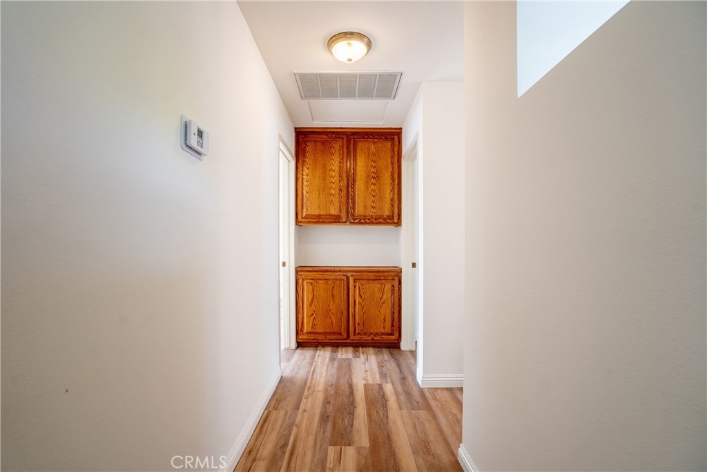 3610 Cartwright Street Pasadena, CA 91107 - Photo 64 of 75 a view of a hallway with wooden floor and a refrigerator