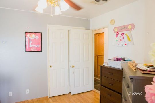 412 Mavis Court Ridgecrest, CA 93555 - Photo 23 of 35 a bedroom with a bed and a dresser