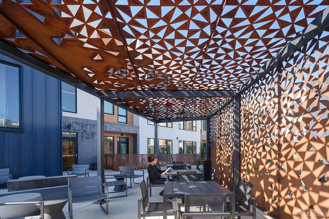 a living room with furniture and large windows