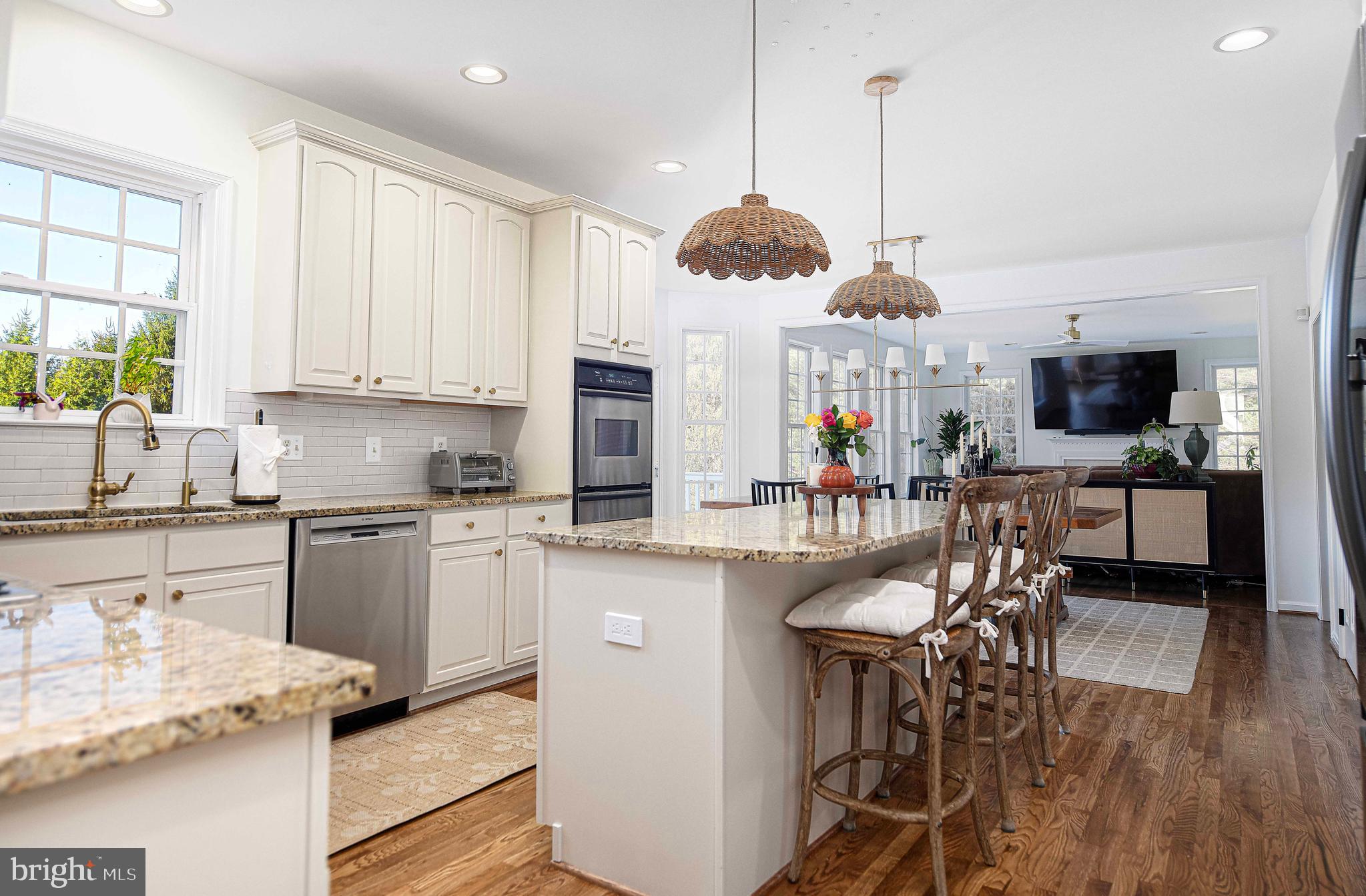 14516 Cuba Road Cockeysville, MD 21030 - Photo 24 of 79 a kitchen with stainless steel appliances granite countertop a stove top oven a sink a dining table and chairs with wooden floor