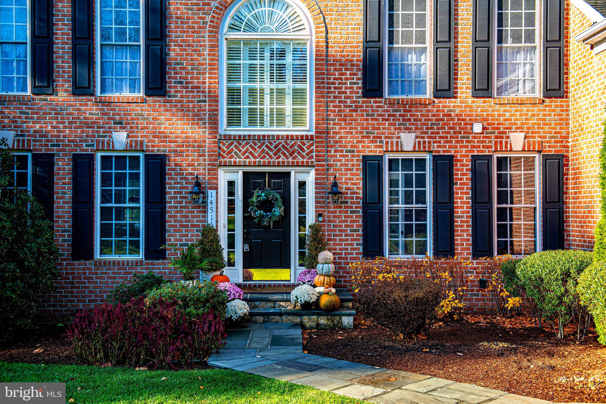14516 Cuba Road Cockeysville, MD 21030 - Photo 68 of 79 a view of a brick house with many windows plants and lawn chairs