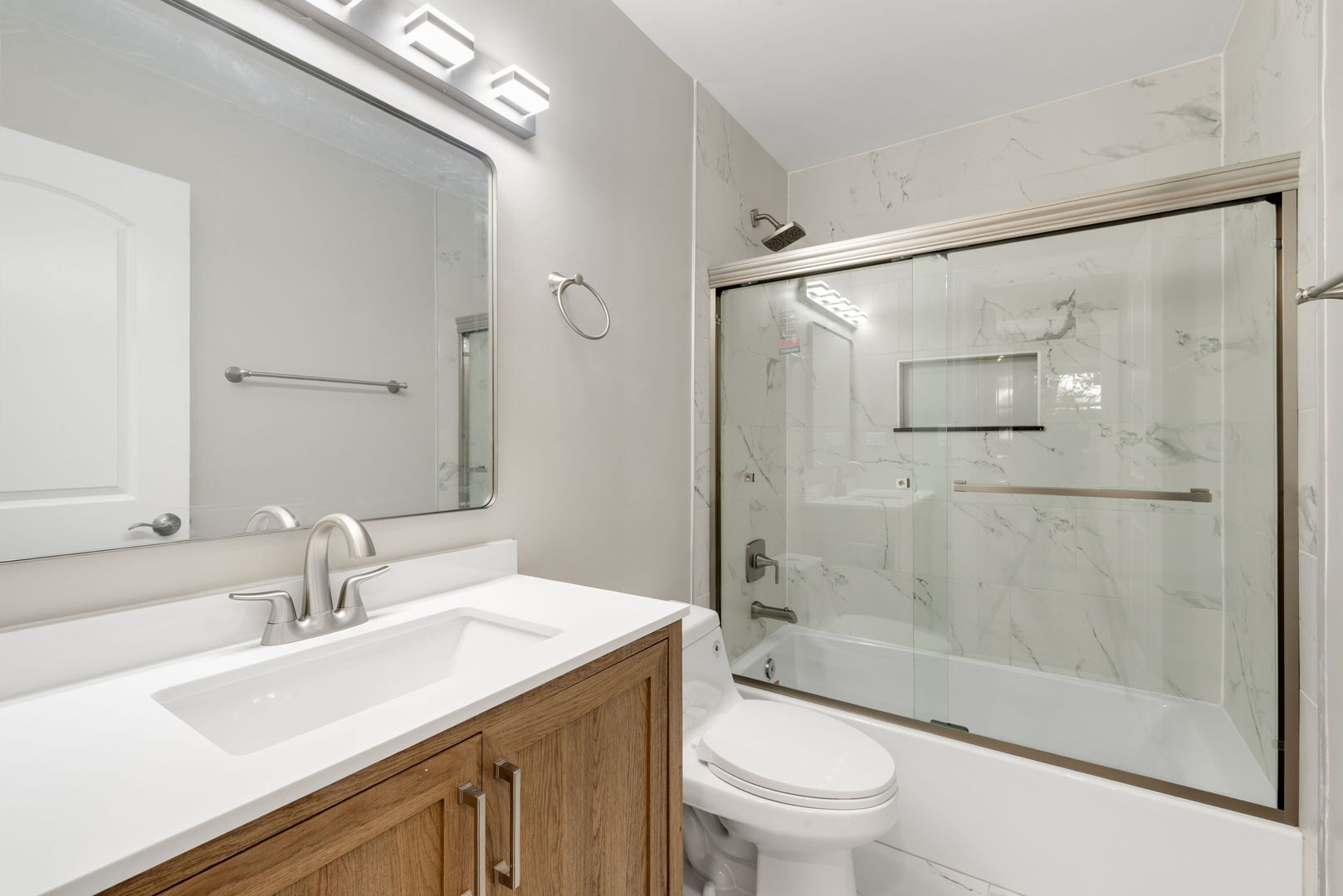 92 North Airlite Street Elgin, IL 60123 - Photo 11 of 25 a bathroom with a sink a toilet and shower