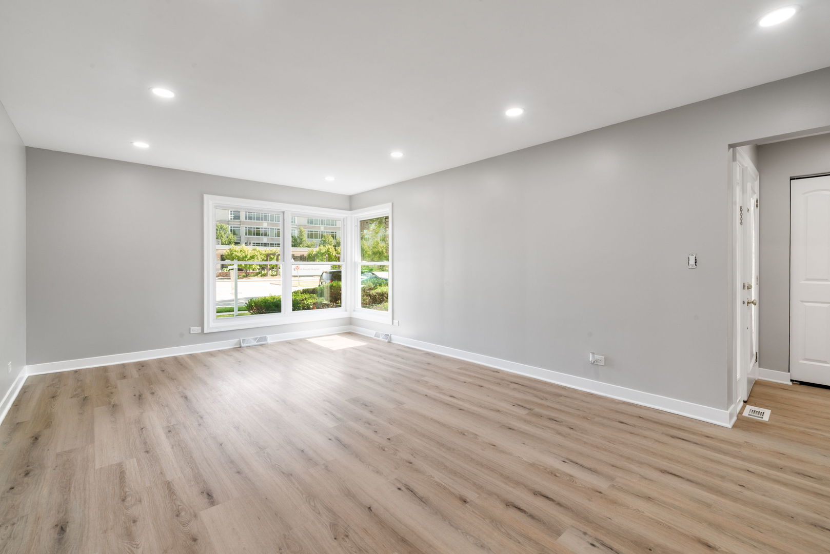 92 North Airlite Street Elgin, IL 60123 - Photo 12 of 25 a view of an empty room with wooden floor and a window