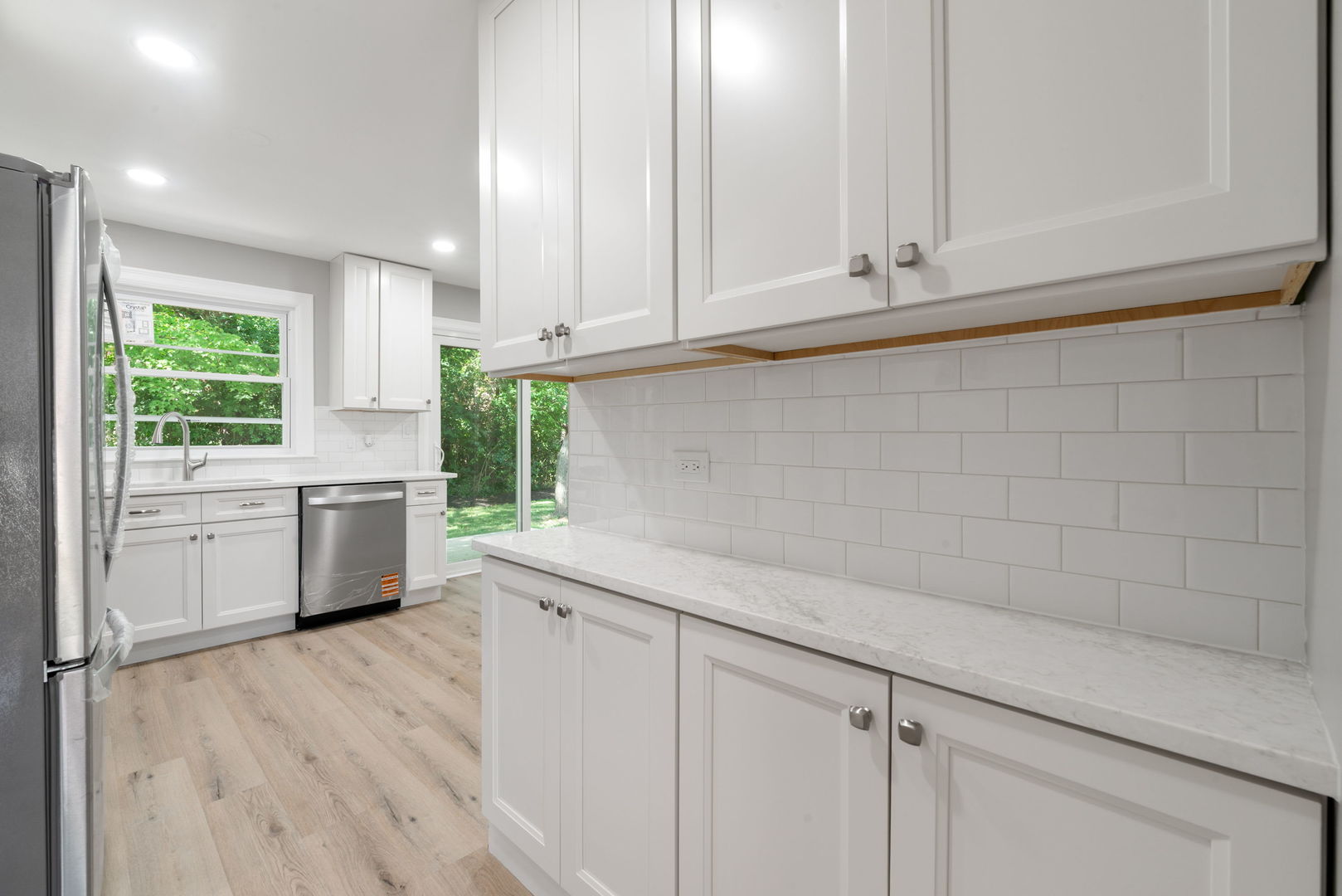 92 North Airlite Street Elgin, IL 60123 - Photo 7 of 25 a kitchen with granite countertop white cabinets and white appliances
