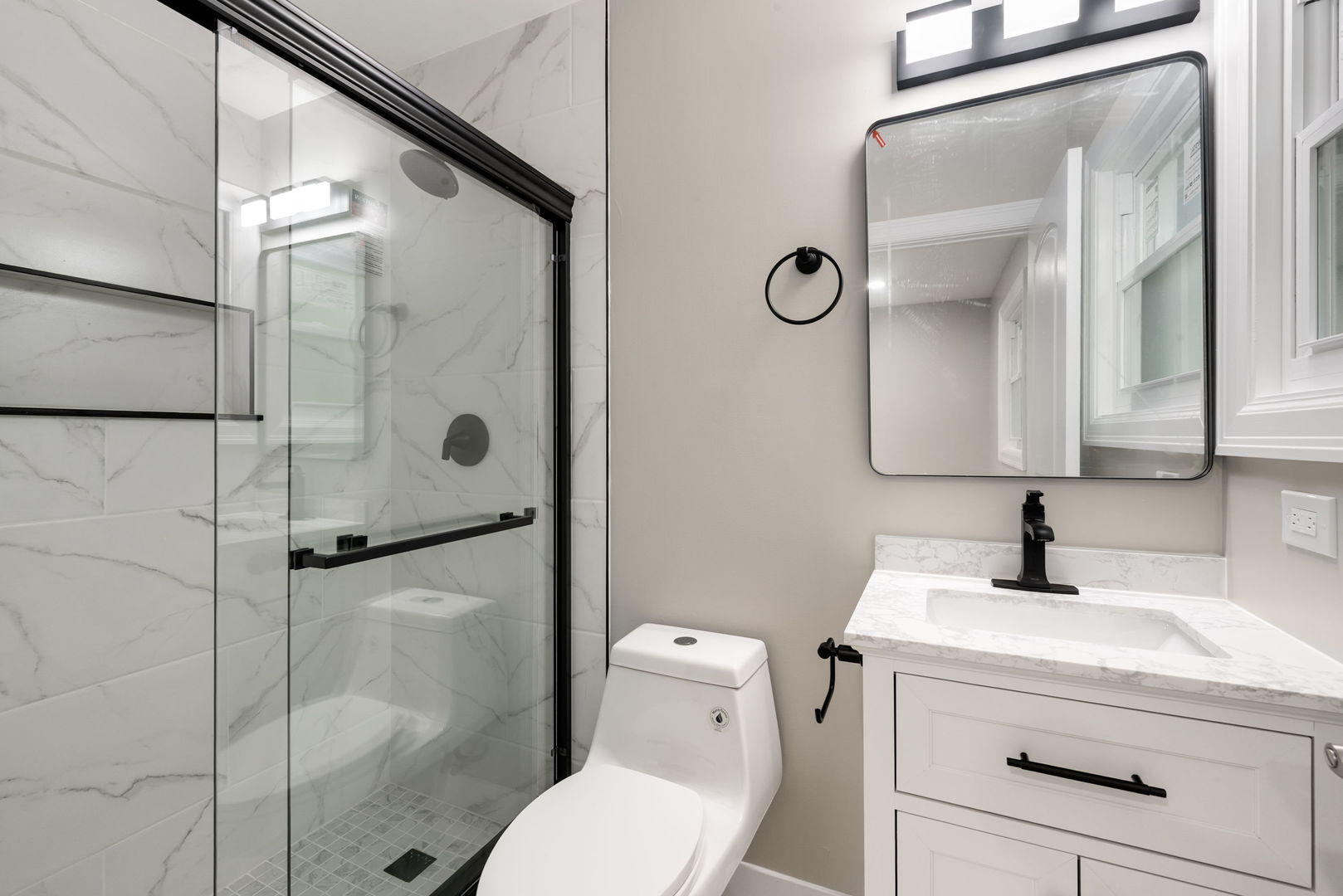 92 North Airlite Street Elgin, IL 60123 - Photo 10 of 25 a bathroom with a toilet sink vanity and shower