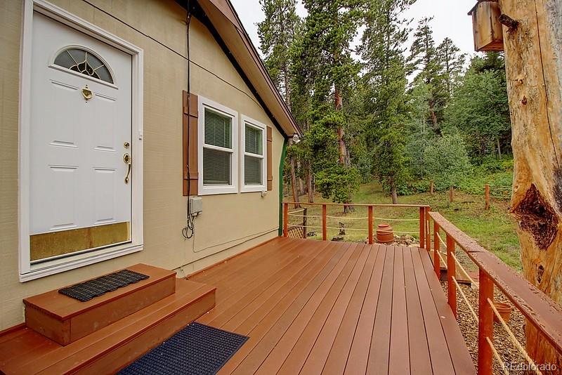 559 Caesar Road Black Hawk, CO 80422 - Photo 5 of 38 a balcony with wooden floor table and chairs