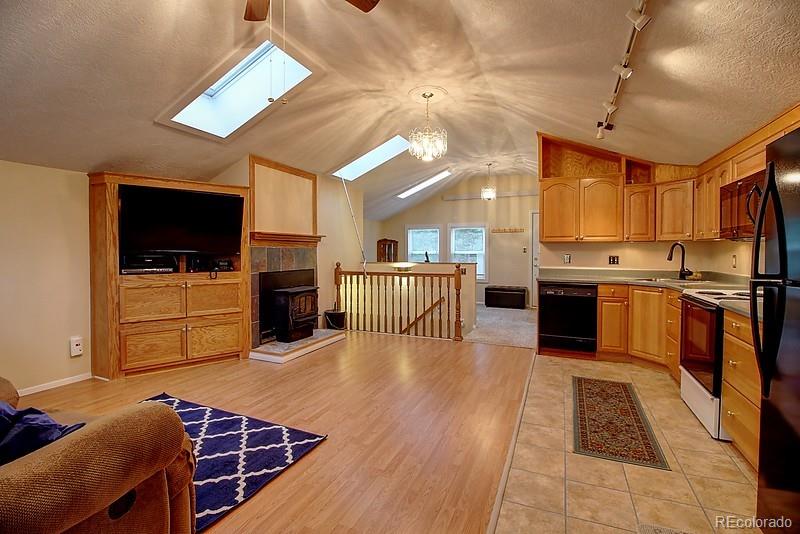 559 Caesar Road Black Hawk, CO 80422 - Photo 8 of 38 a large kitchen with cabinets and stainless steel appliances