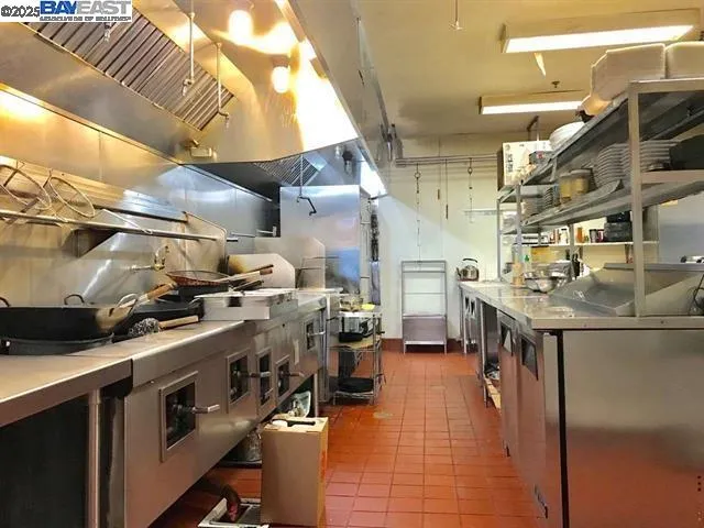 a kitchen with a stove and a refrigerator