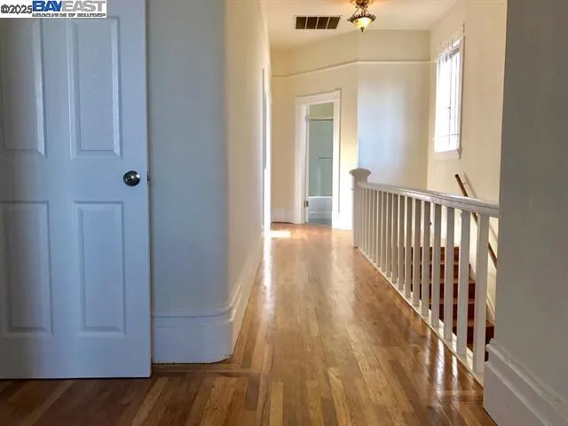 a kitchen with stainless steel appliances granite countertop wooden cabinets a stove a sink and dishwasher with wooden floor