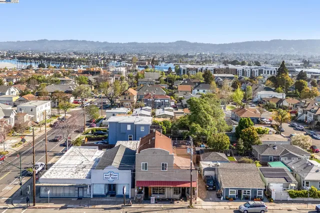 an aerial view of residential houses with city view