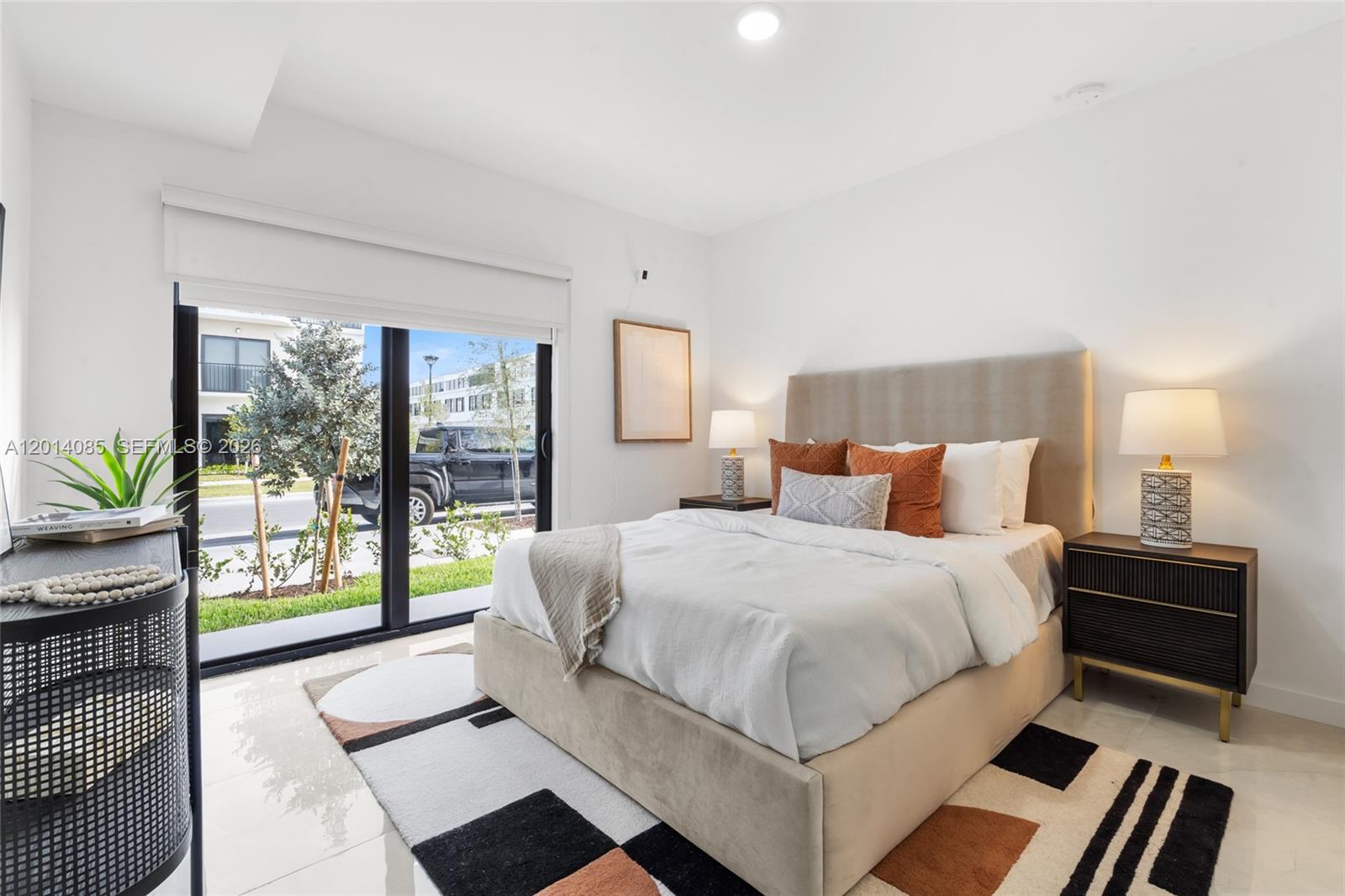 14530 Southwest 261st Terrace, Unit 1 Homestead, FL 33032 - Photo 11 of 17 a bedroom with a bed and a large window
