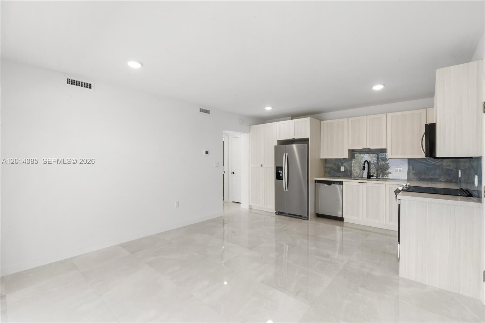 14530 Southwest 261st Terrace, Unit 1 Homestead, FL 33032 - Photo 3 of 17 a large kitchen with cabinets and stainless steel appliances