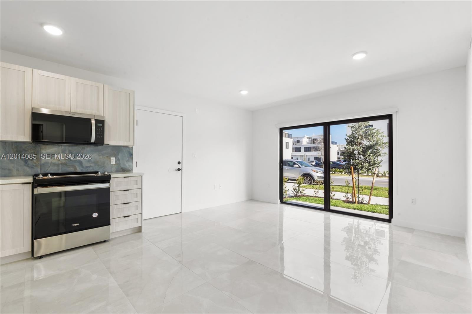 14530 Southwest 261st Terrace, Unit 1 Homestead, FL 33032 - Photo 6 of 17 a view of an empty room with a fireplace and a window