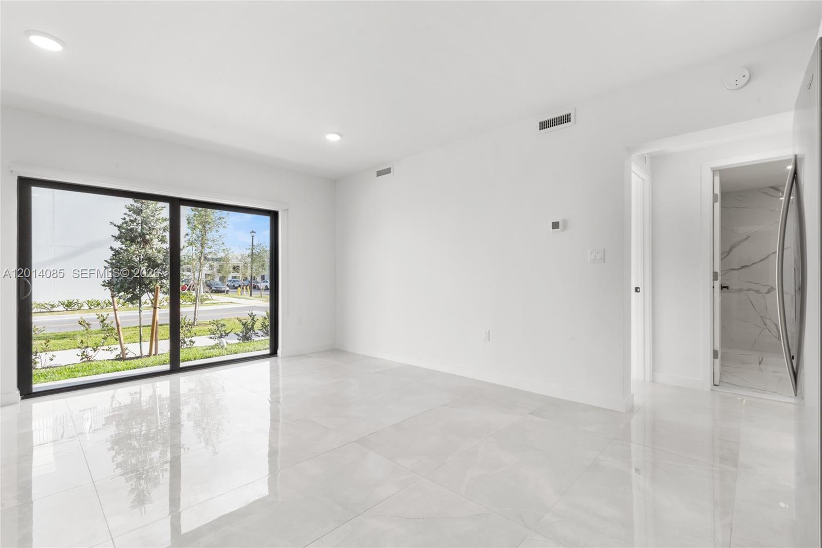 14530 Southwest 261st Terrace, Unit 1 Homestead, FL 33032 - Photo 7 of 17 a view of an empty room with a window