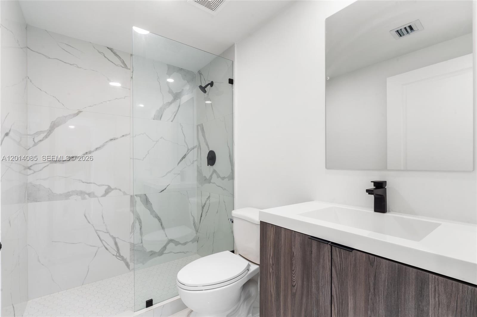 14530 Southwest 261st Terrace, Unit 1 Homestead, FL 33032 - Photo 8 of 17 a bathroom with a sink toilet vanity and shower