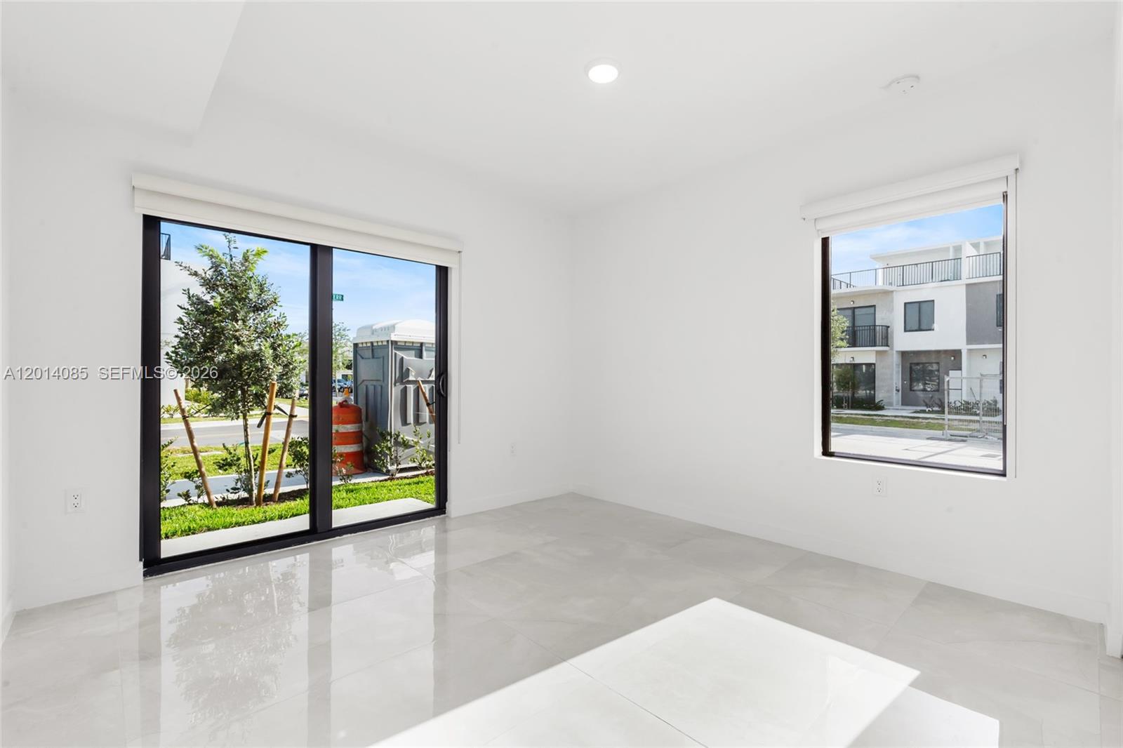 14530 Southwest 261st Terrace, Unit 1 Homestead, FL 33032 - Photo 9 of 17 an empty room with windows